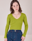 Hana is 5'3" and wearing P Long Sleeve V-Neck Tee in Gross Green