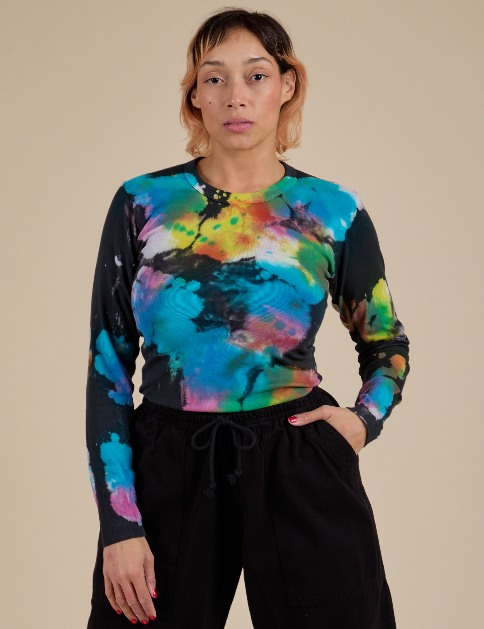 Tiara is 5’4” and wearing S Long Sleeve Baby Tee in Rainbow Magic Waters