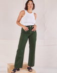 Tiara is wearing Organic Work Pants in Swamp Green and Racerback Tank in vintage tee off-white