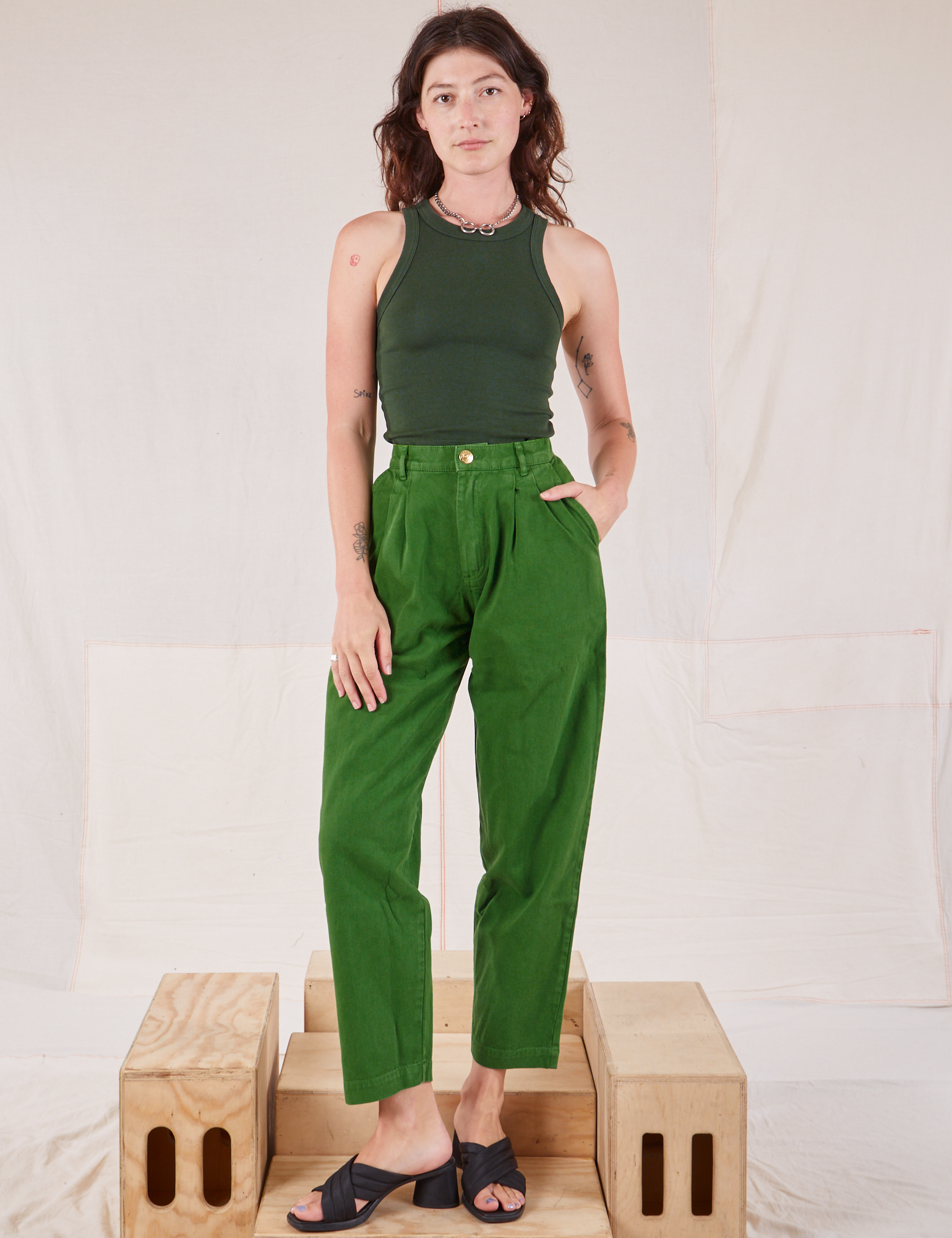 Alex is wearing Racerback Tank in Swamp Green and lawn green Trousers