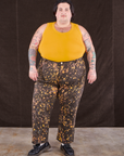 Sam is 5'10" and wearing 3XL Marble Splatter Work Pants in Espresso Brown paired with mustard yellow Tank Top