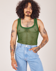 Jesse is wearing Mesh Tank Top in Lawn Green and light wash Sailor Jeans