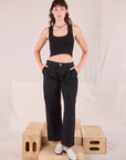 Alex is wearing Mid-Rise Pleated Trousers in Basic Black and black Cropped Tank