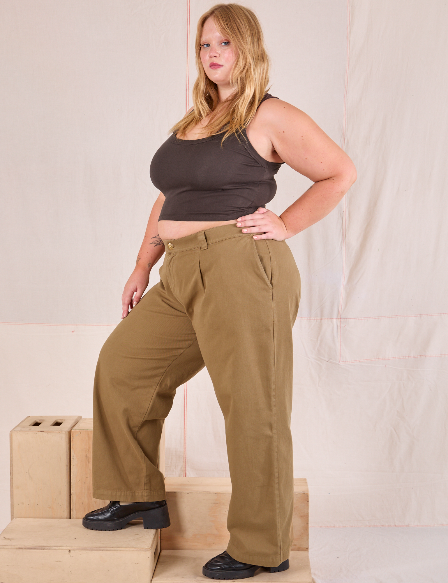 Side view of Mid-Rise Pleated Trousers in Desert Brown and espresso brown Cropped Tank in Juliet