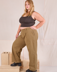 Side view of Mid-Rise Pleated Trousers in Desert Brown and espresso brown Cropped Tank in Juliet