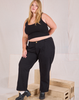 Juliet is wearing Mid-Rise Work Pants in Basic Black and black Cropped Tank