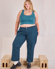 Juliet is wearing Mid-Rise Work Pants in Lagoon and marine blue Cropped Tank