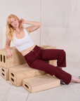 Margaret is wearing Mid-Rise Work Pants in Red Wine and Cropped Tank in vintage tee off-white