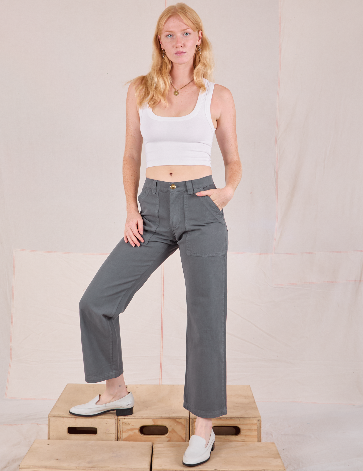 Margaret is wearing Mid-Rise Work Pants in Slate Grey and Cropped Tank in vintage tee off-white