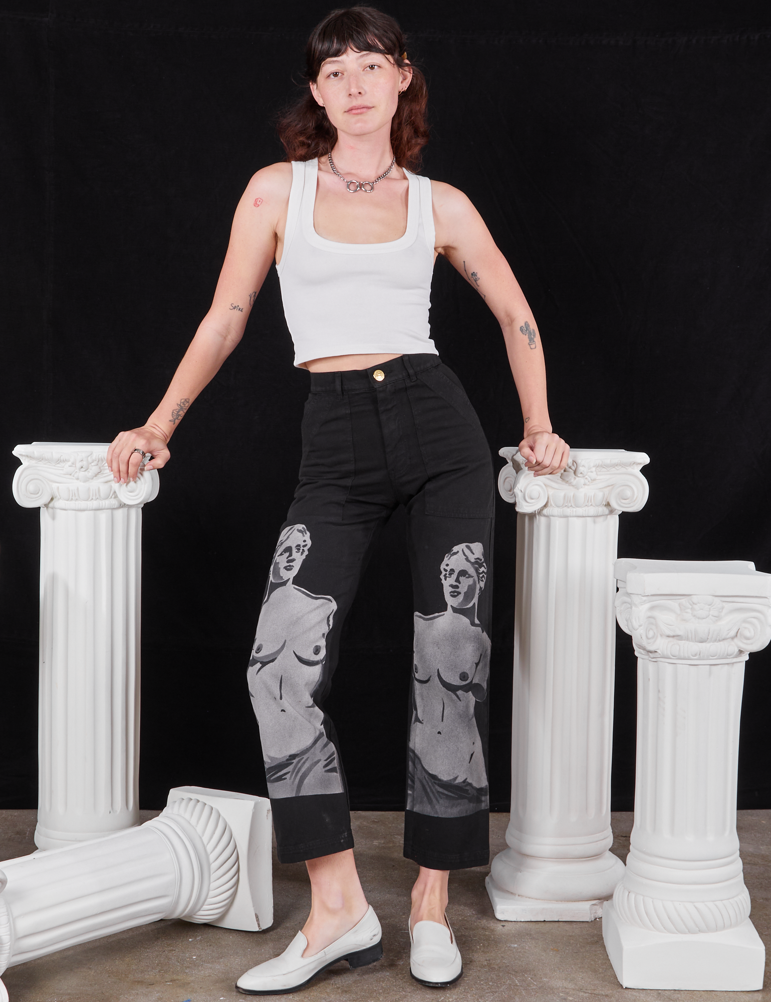 Alex is 5&#39;8&quot; and wearing XXS Black Venus Work Pants paired with vintage off-white Cropped Tank Top