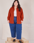 Ashley is wearing Oversize Overshirt in Paprika and dark wash Petite Denim Trousers