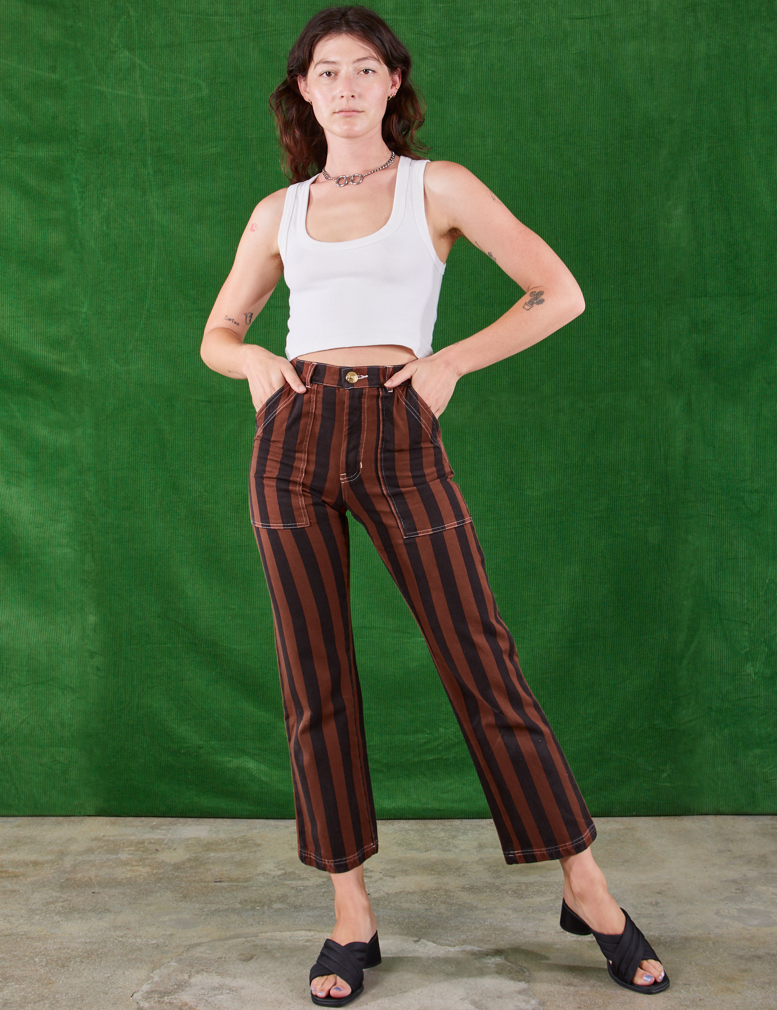 Alex is wearing Black Stripe Work Pants in Fudgesicle Brown and Cropped Tank in vintage tee off-white