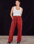 Tiara is 5'4" and wearing S Black Stripe Work Pants in Mustang Red paired with Cropped Tank in vintage tee off-white