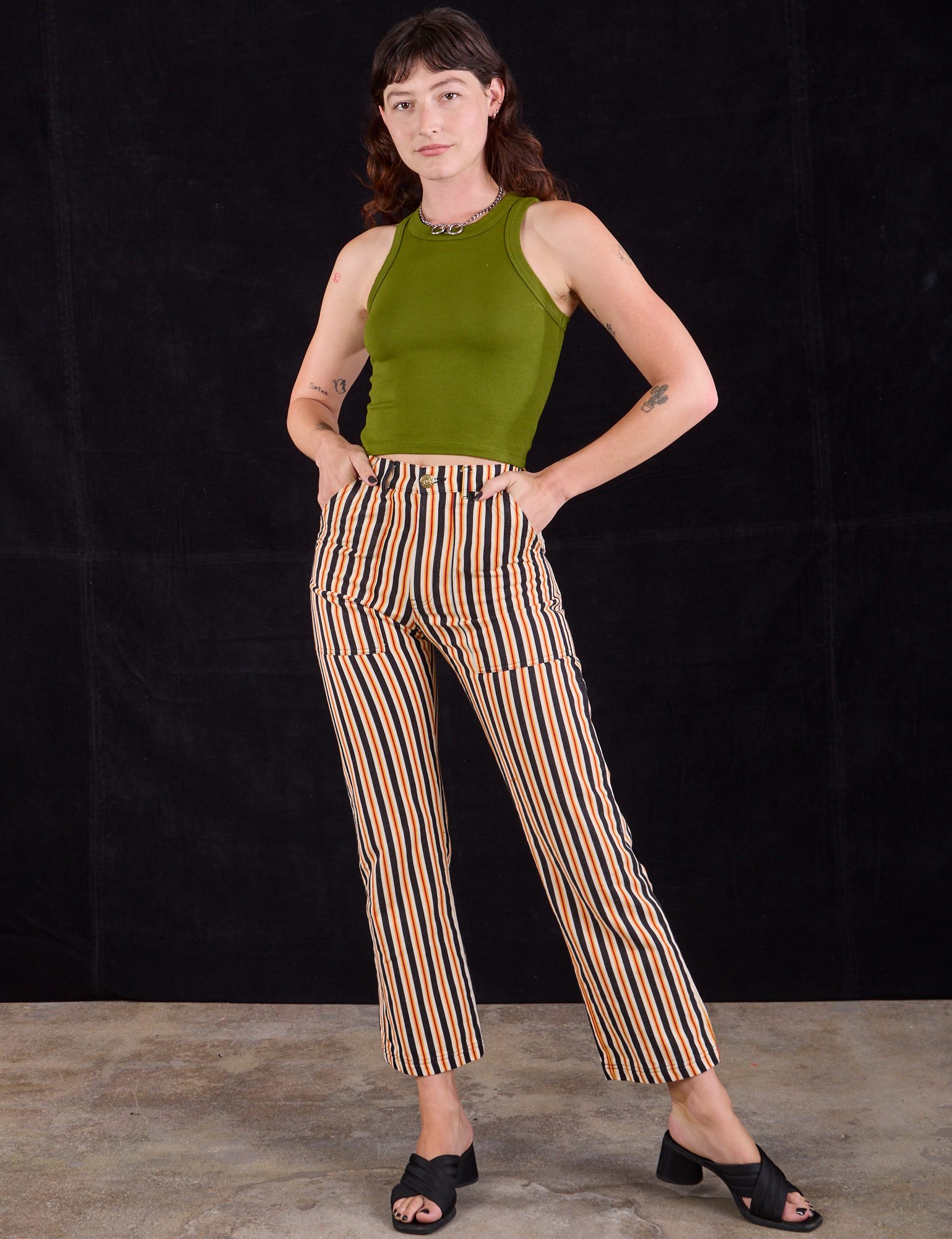 Alex is wearing Work Pants in Autumn Stripe and summer olive Racerback Tank