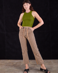 Alex is wearing Work Pants in Autumn Stripe and summer olive Racerback Tank