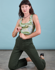 Alex is kneeling and wearing Cropped Tank Top in Ocean and Sky and swamp green Work Pants