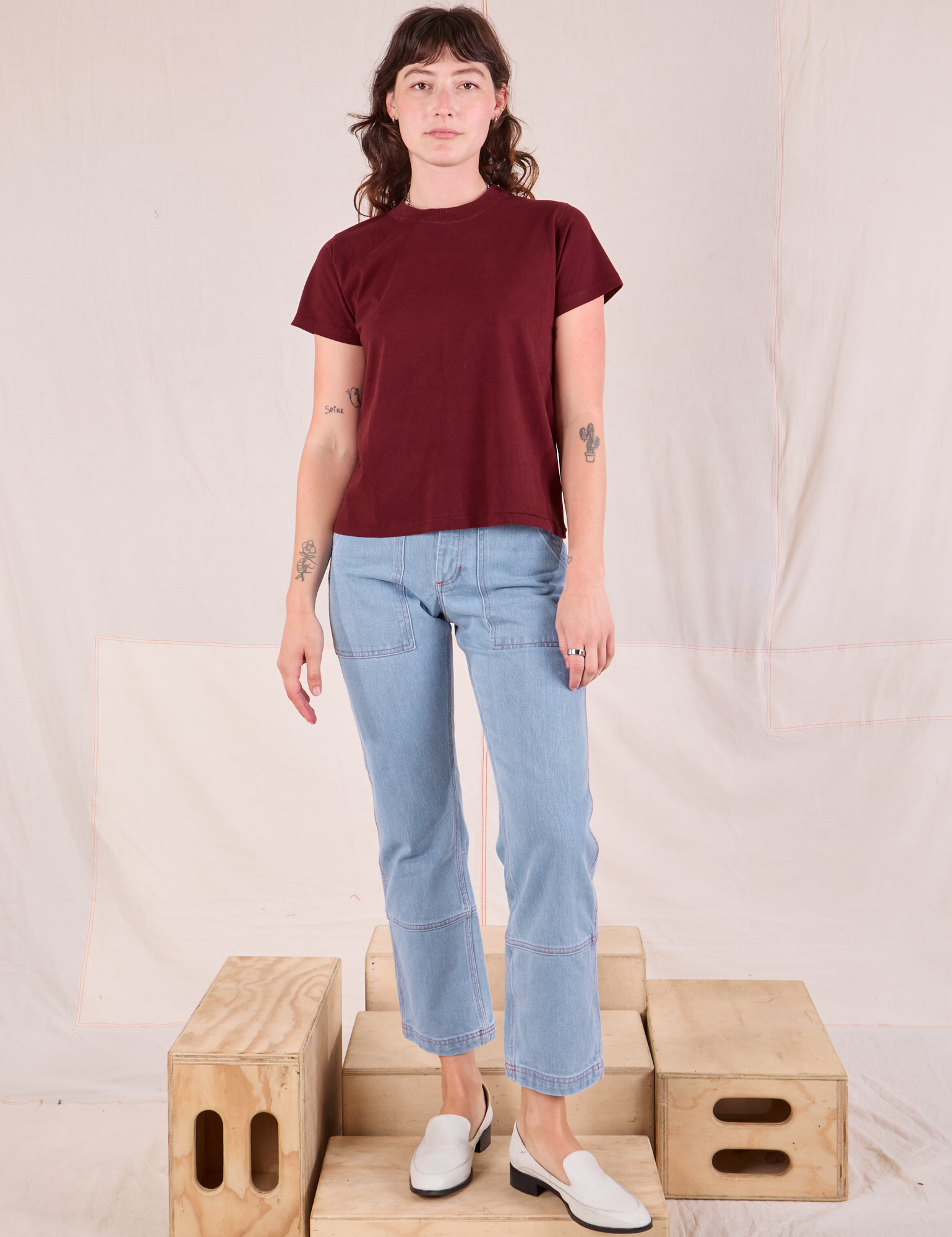 Alex is wearing Organic Vintage Tee in Red Wine and light wash Carpenter Jeans