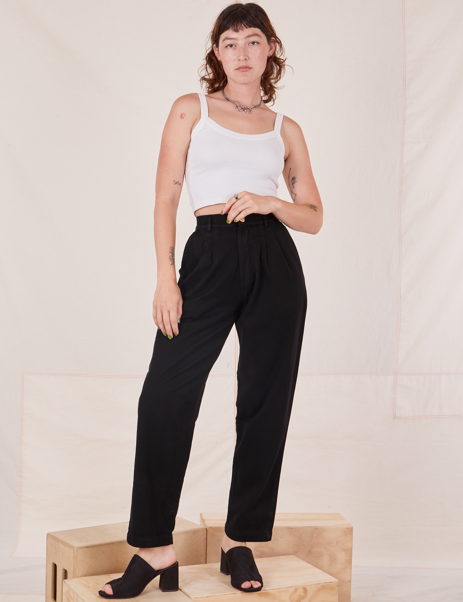 Alex is 5&#39;8&quot; and wearing XXS Organic Trousers in Basic Black paired with vintage off-white Cropped Cami
