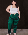 Ashley is 5’7” and wearing 1XL Black Stripe Work Pants in Hunter paired with vintage off-white Cropped Tank Top