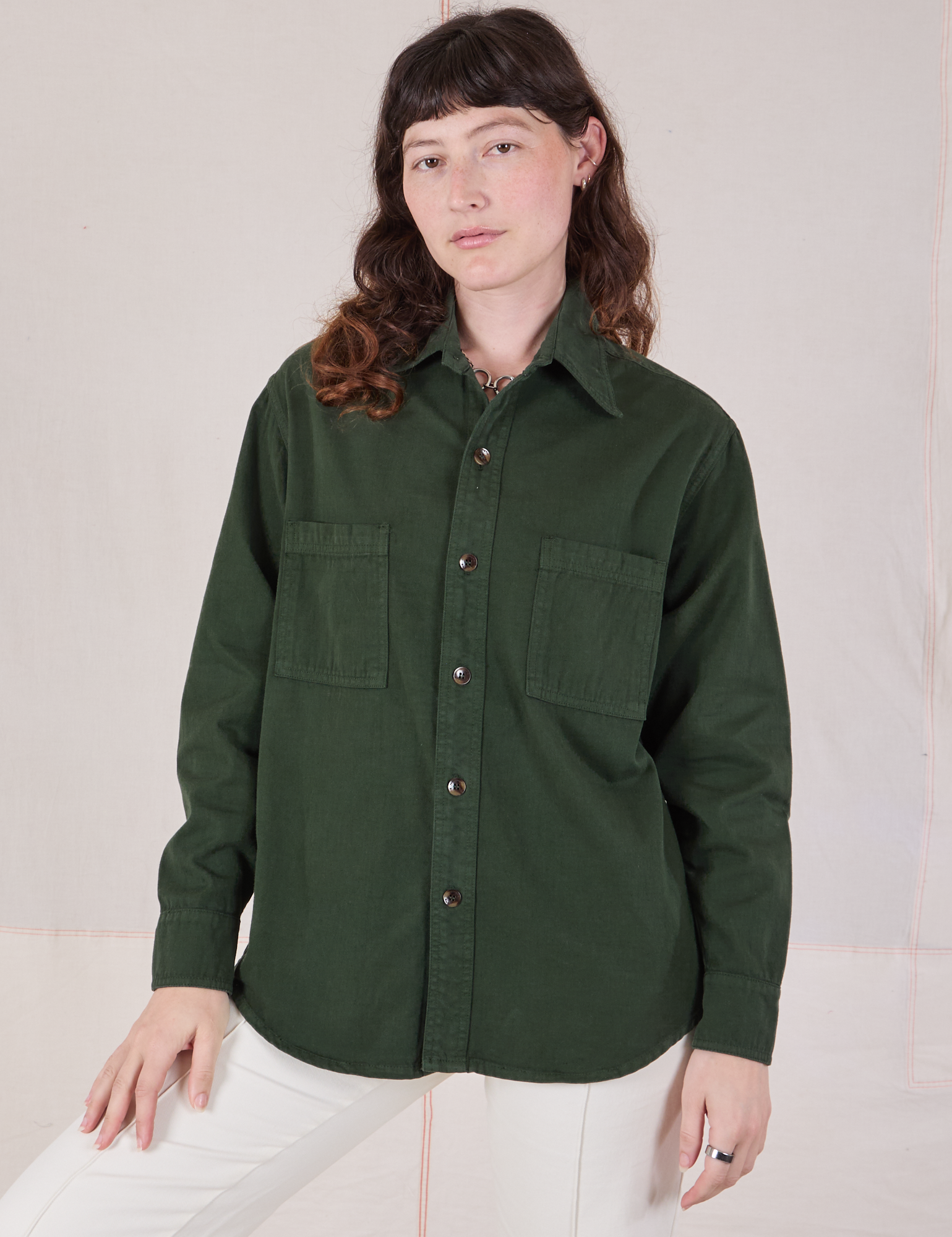 Alex is wearing a buttoned up Twill Overshirt in Swamp Green