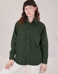 Alex is wearing a buttoned up Twill Overshirt in Swamp Green