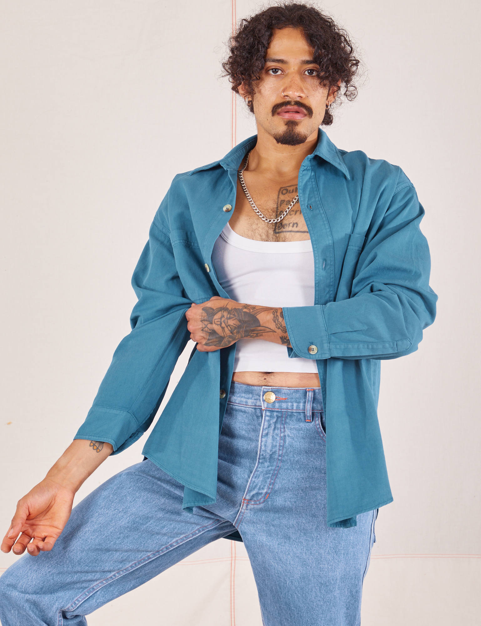 Jesse is wearing Oversize Overshirt in Marine Blue with a vintage off-white Cropped Tank Top underneath