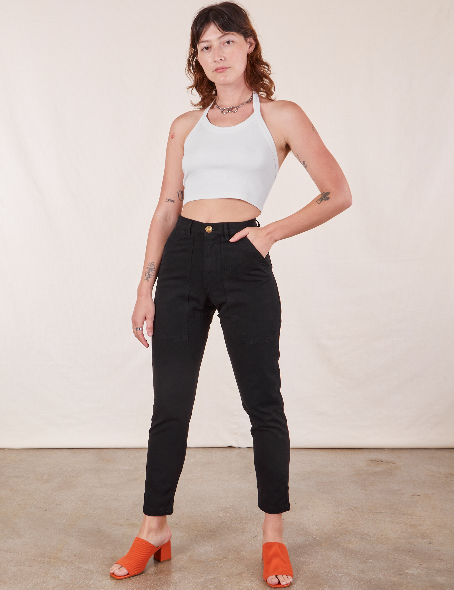 Alex is 5'8" and wearing XXS Pencil Pants in Basic Black paired with vintage off-white Halter Top