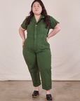 Ashley is 5’7” and wearing 1XL Petite Short Sleeve Jumpsuit in Dark Emerald Green