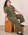 Ari is wearing Petite Short Sleeve Jumpsuit in Surplus Green