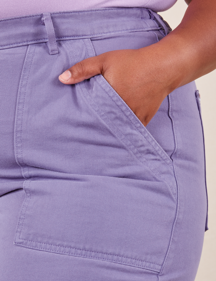 Front pocket close up of Work Pants in Faded Grape. Worn by Morgan with her hand in the pocket.