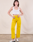 Work Pants in Golden Yellow and Cropped Tank in Vintage Tee Off-White worn by Alex