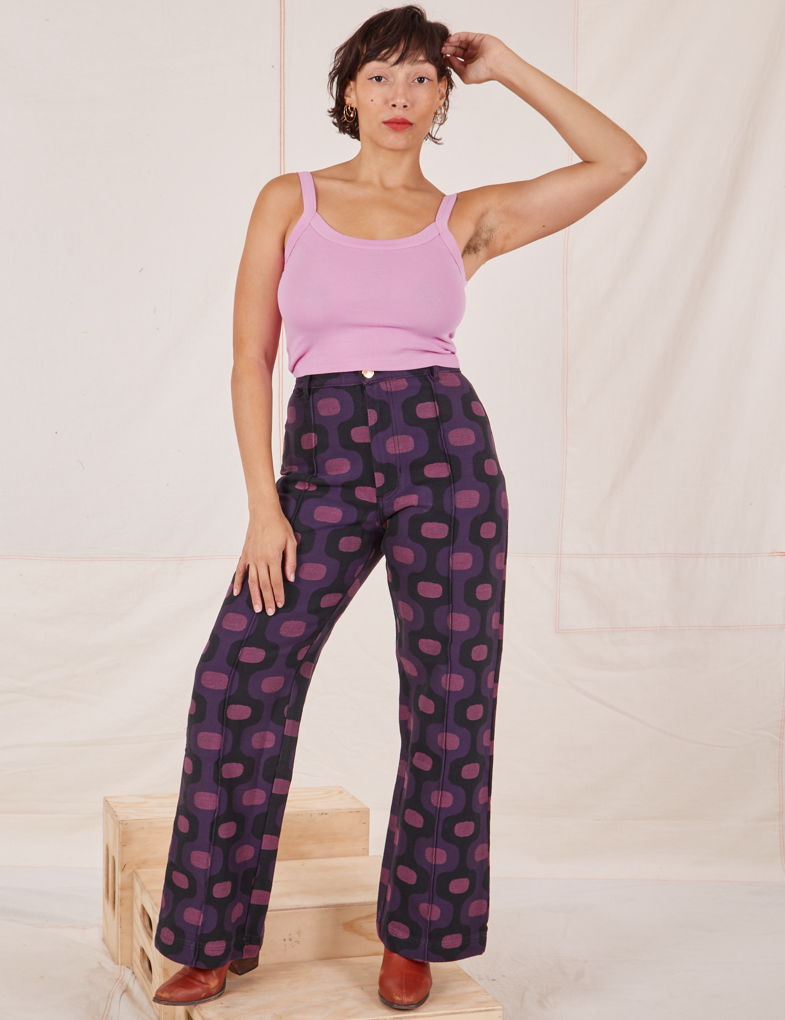 Tiara is 5'4" and wearing S Western Pants in Purple Tile Jacquard paired with bubblegum pink Cami