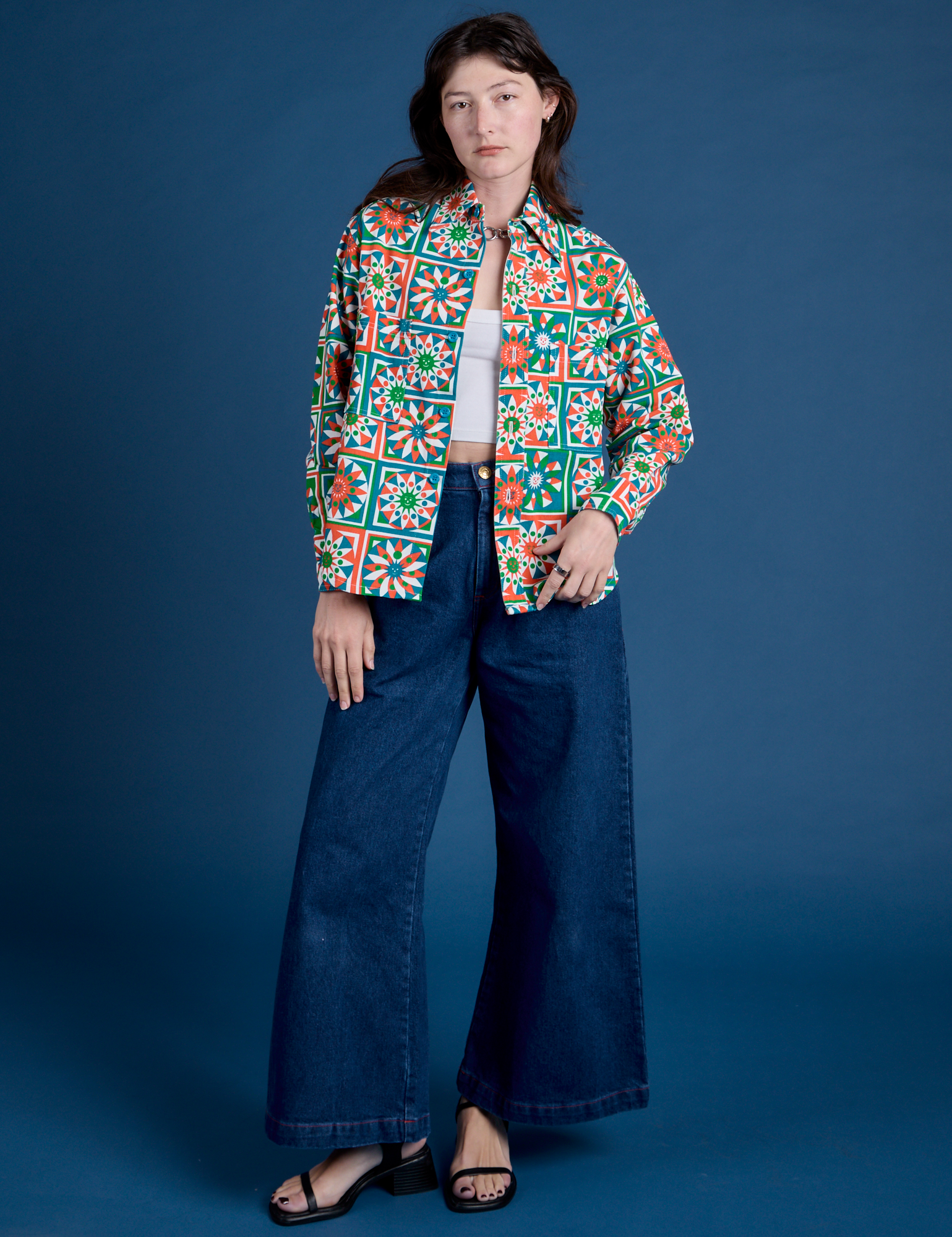 Alex is wearing Cropped Overshirt in Quilt Print paired with dark wash Indigo Wide Leg Trousers