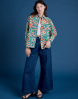 Alex is wearing Cropped Overshirt in Quilt Print paired with dark wash Indigo Wide Leg Trousers