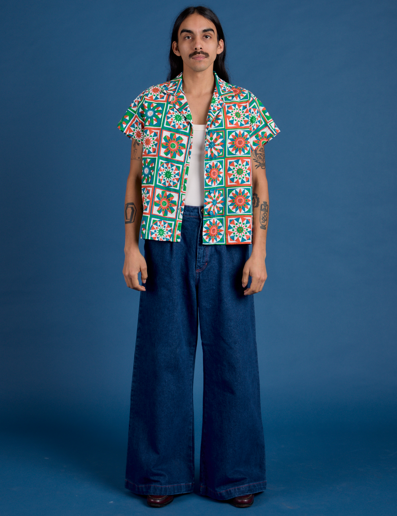 Anthony is wearing Quilt Print Pantry Button-Up and dark wash Indigo Wide Leg Trousers
