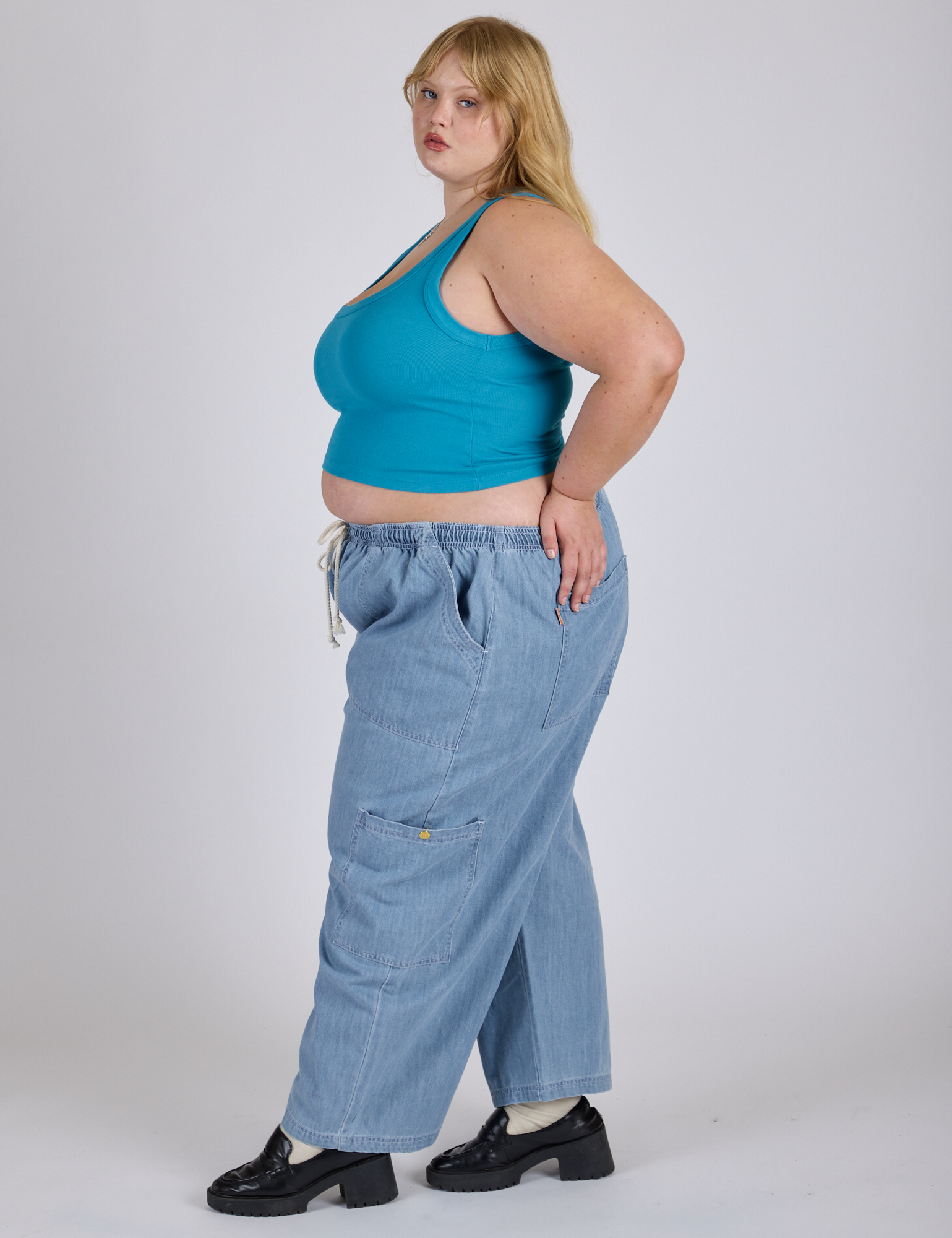 Side view of Cropped Tank Top in Hawaiian Blue and light wash Denim Drop Pocket Pants