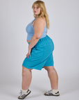 Side view of Longline Work Shorts in Hawaiian Blue and baby blue Racerback Tank on Juliet