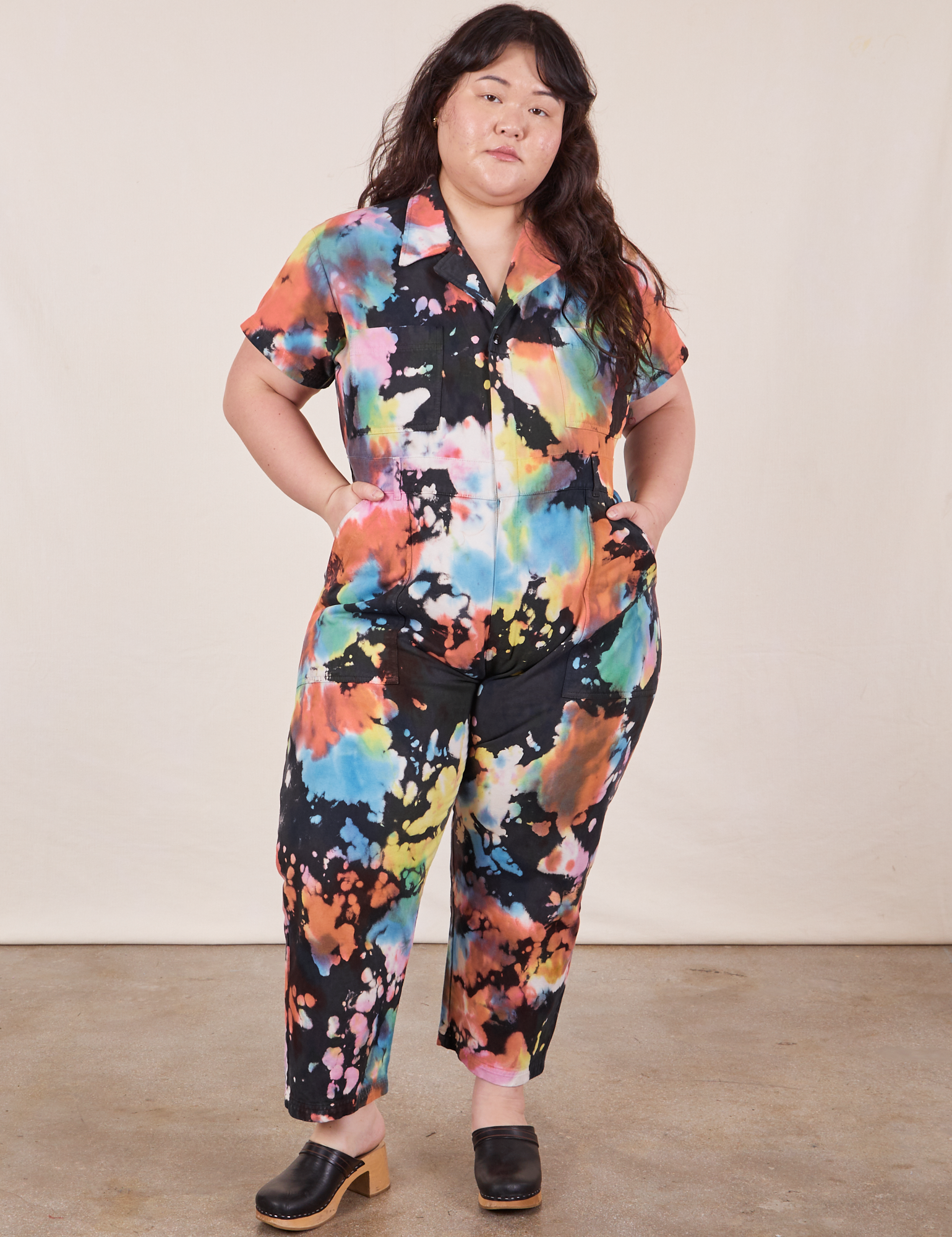 Ashley is 5&#39;7&quot; and wearing 1XL Petite Petite Short Sleeve Jumpsuit in Rainbow Magic Waters