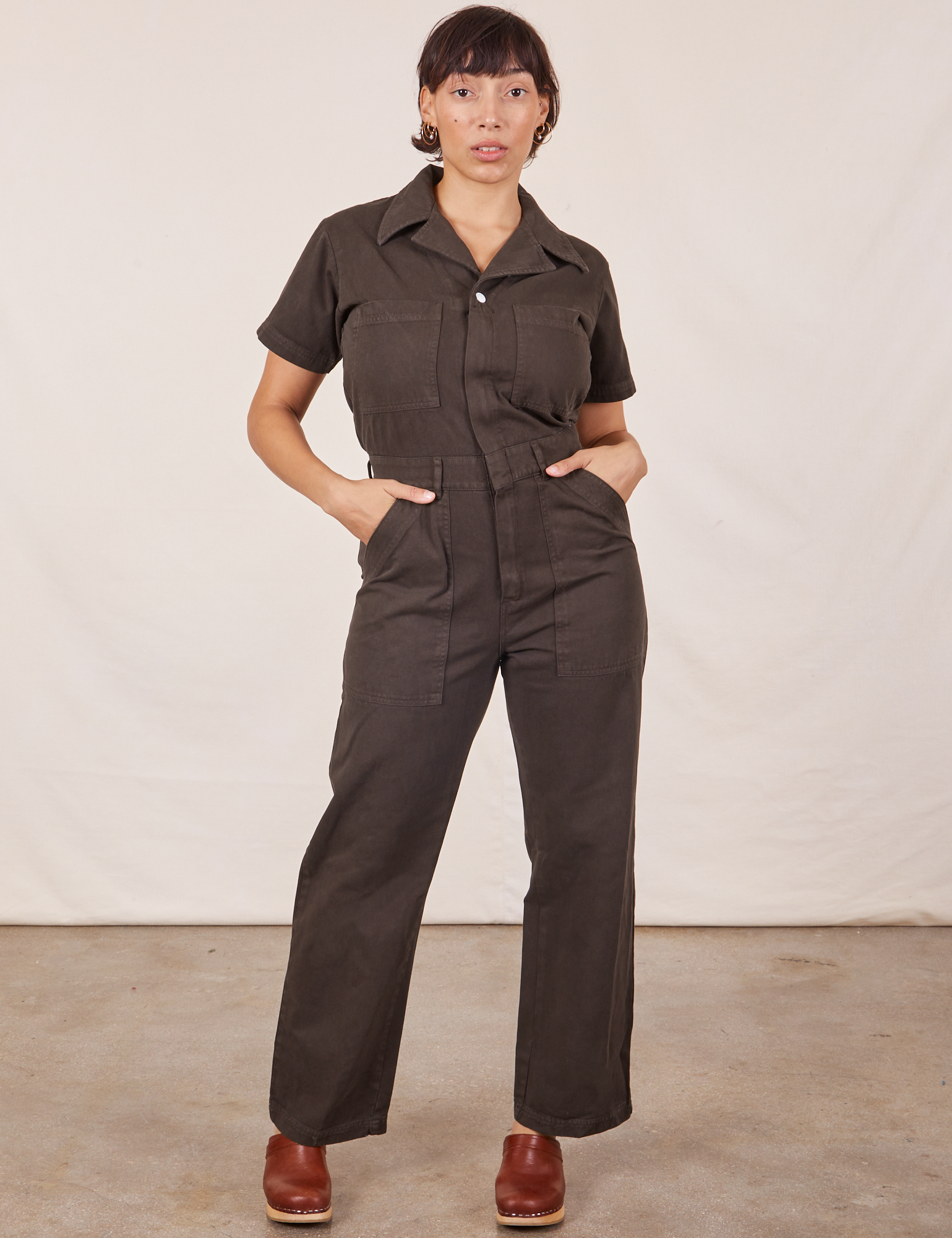 Tiara is 5&#39;4&quot; and wearing S Short Sleeve Jumpsuit in Espresso Brown 
