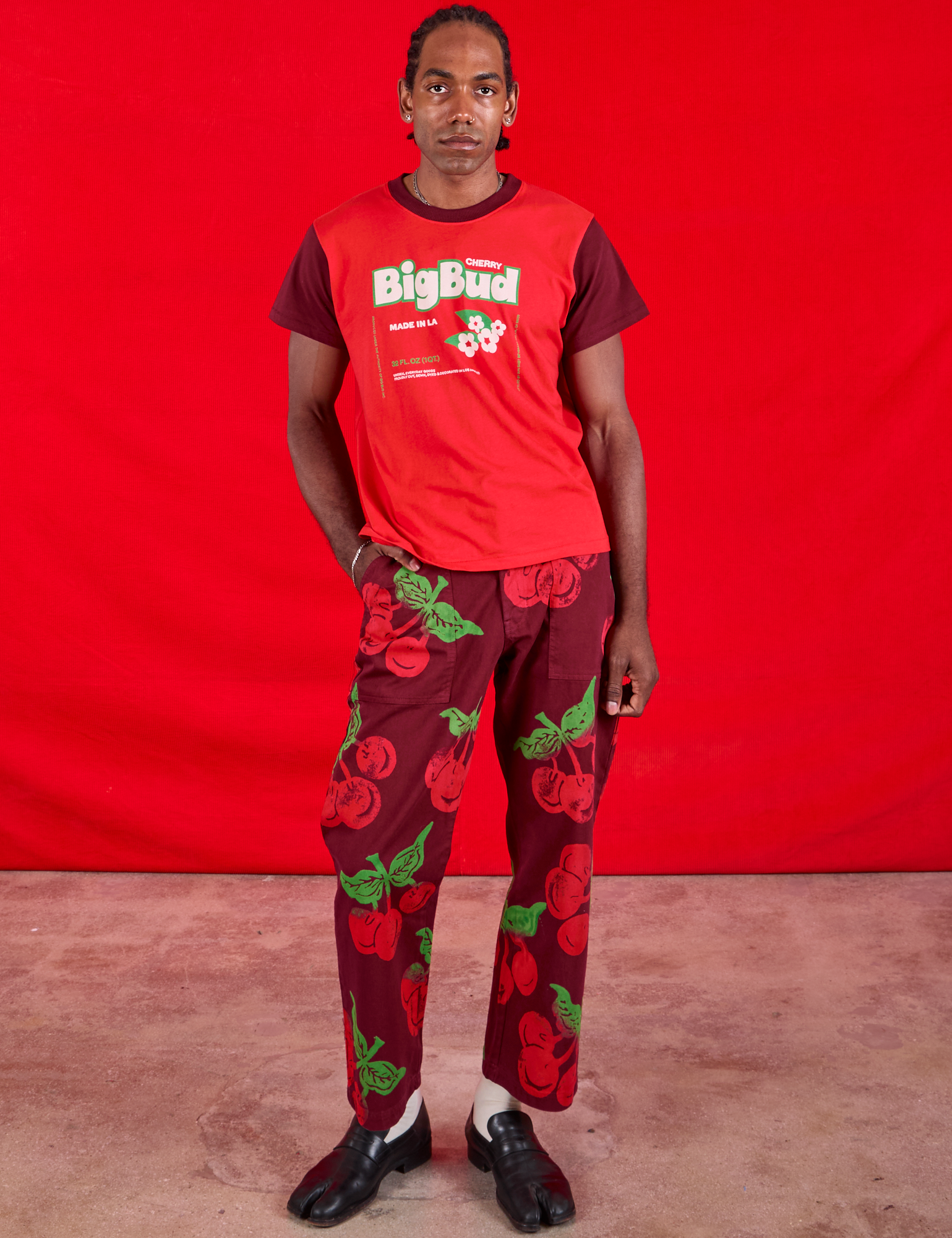 Jerrod is wearing Vintage Tee in Cherry Soda and Paintstamped Work Pants in Cherry