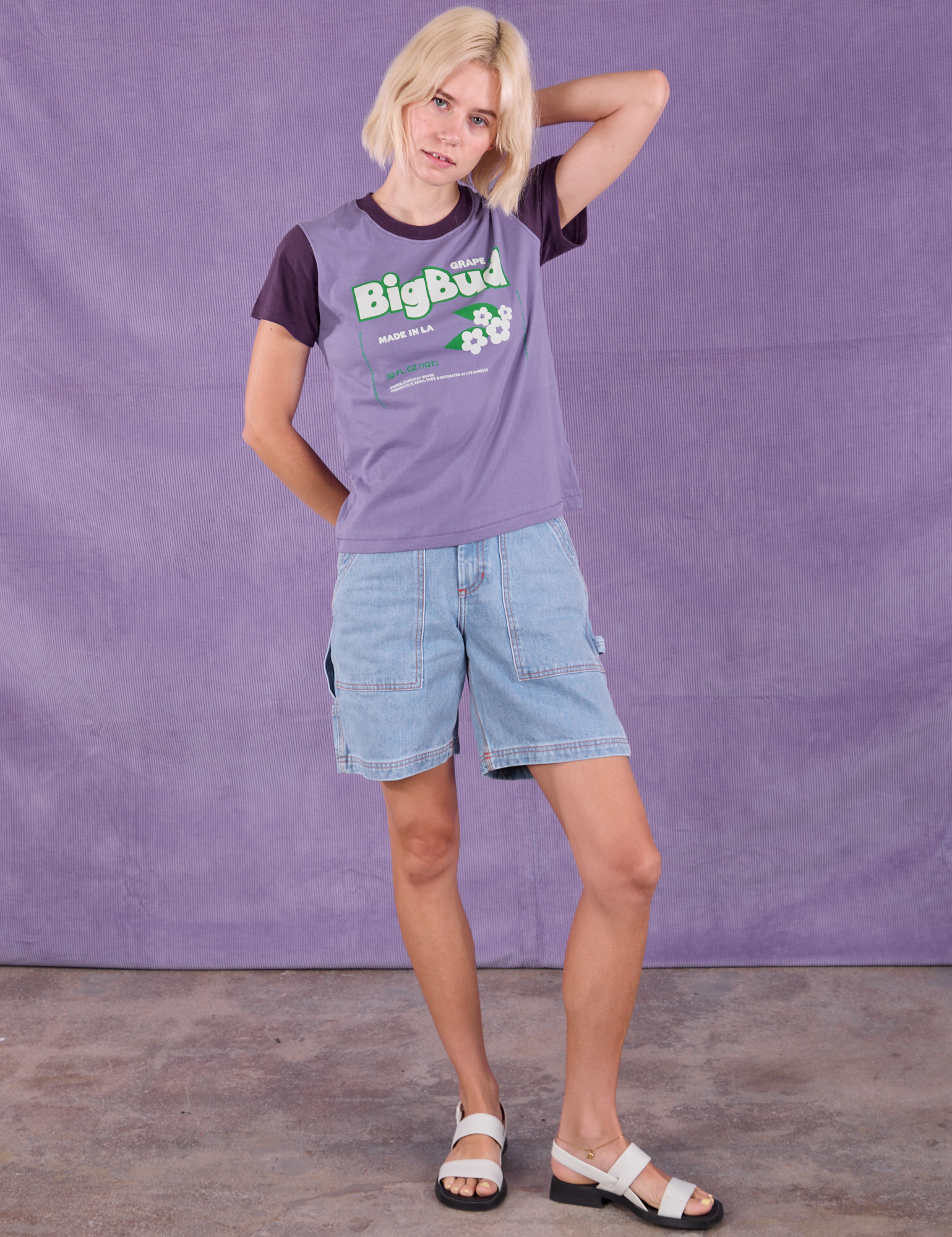 Madeline is wearing Vintage Tee in Grape Soda and light wash Carpenter Shorts