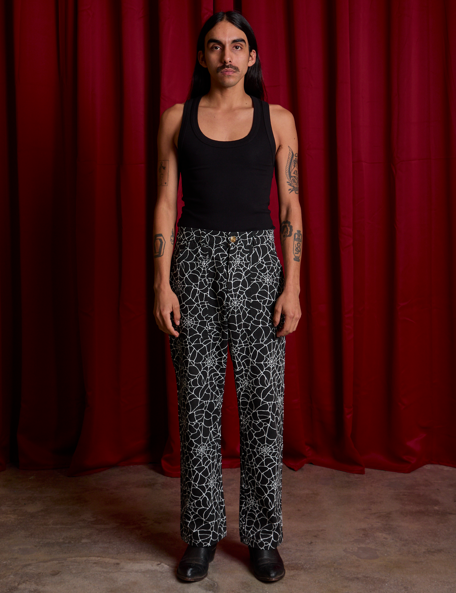 Work Pants in Spiderwebs and Black Cropped Tank worn by Anthony