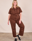 Lish is 5'8" and wearing L Short Sleeve Jumpsuit in Fudgesicle Brown