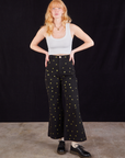 Margaret is wearing Star Bell Bottoms in Black and a Cropped Tank in vintage tee off-white