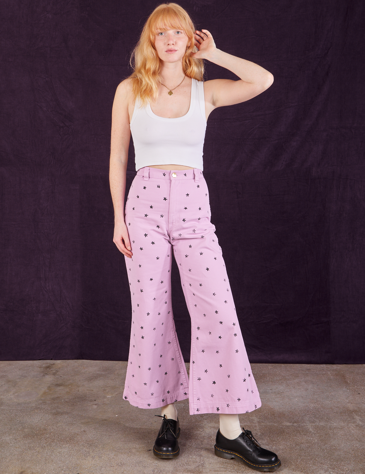 Margaret is wearing Star Bell Bottoms in Lilac Purple and Cropped Tank in vintage tee off-white