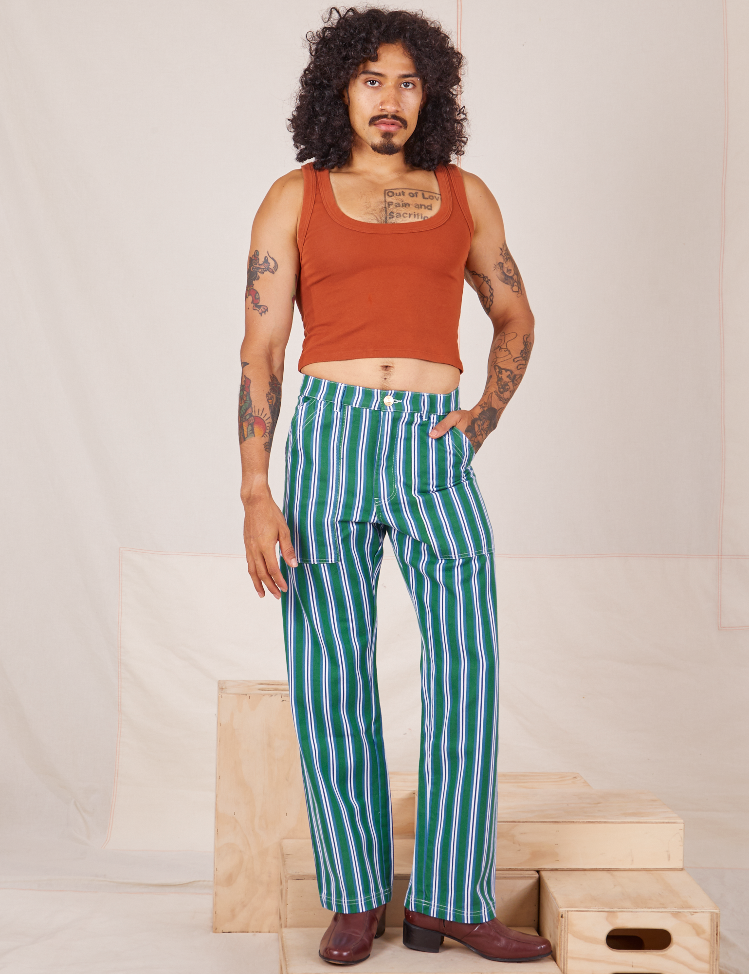 Jesse is 5&#39;8&quot; and wearing XS Stripe Work Pants in Green paired with burnt terracotta Cropped Tank