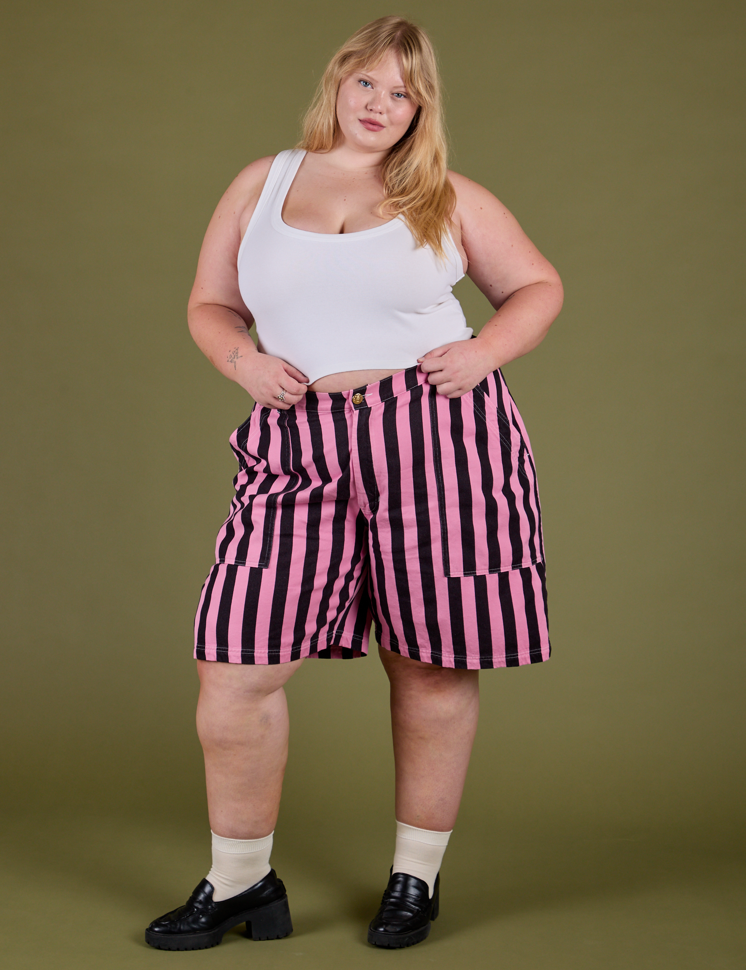 Juliet is wearing Longline Work Shorts in Bubblegum Pink and Cropped Tank in Vintage Tee White