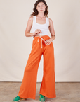 Alex is wearing Wide Leg Sweat Pants in Sunset Orange and Cropped Tank in vintage tee off-white