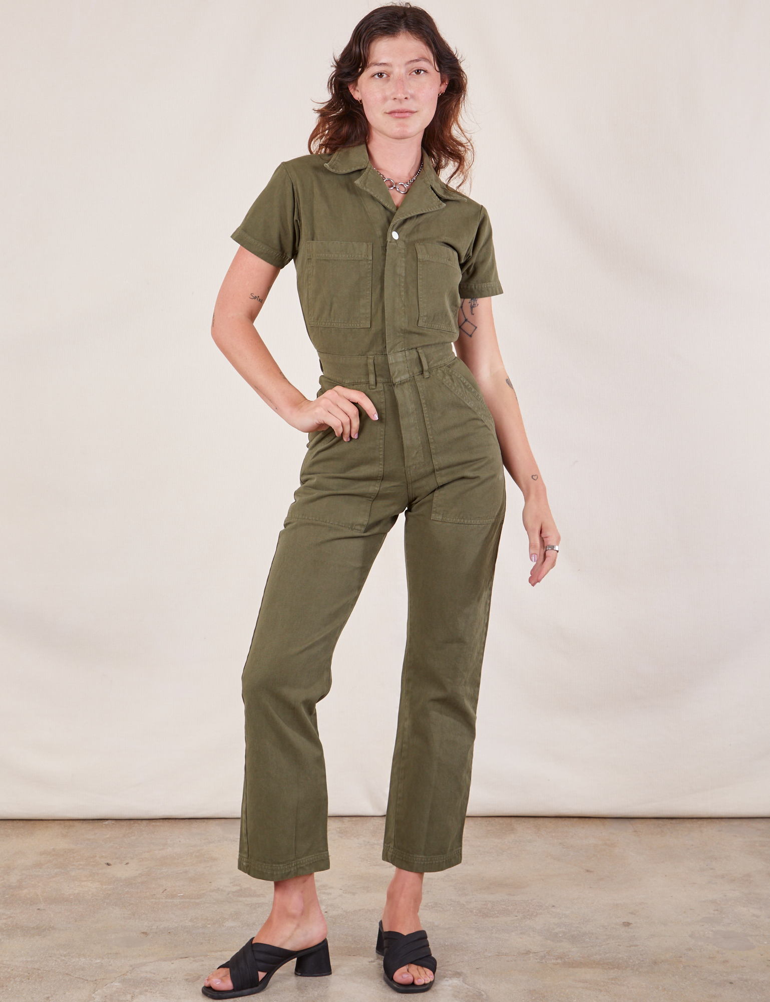 Alex is 5'8" and wearing XXS Short Sleeve Jumpsuit in Surplus Green