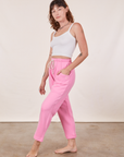 Angled view of Cropped Rolled Cuff Sweatpants in Bubblegum Pink and vintage off-white Cami on Alex